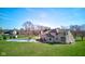 Spacious backyard featuring a covered pool, patio set, and lush green lawn, perfect for outdoor entertaining at 2274 W Huntsville Rd, Pendleton, IN 46064