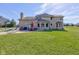 Expansive backyard features a brick house, lush green grass, a patio, and outdoor seating for enjoyment at 2274 W Huntsville Rd, Pendleton, IN 46064