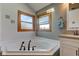 Relaxing bathroom featuring a corner jacuzzi tub and a modern vanity, creating a spa-like retreat at 2274 W Huntsville Rd, Pendleton, IN 46064