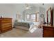 Bright bedroom with vaulted ceilings, bay windows, and hardwood dressers for storage at 2274 W Huntsville Rd, Pendleton, IN 46064