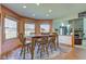 Sunlit dining room features a wooden table set, hardwood floors, and a bay window with beautiful natural lighting at 2274 W Huntsville Rd, Pendleton, IN 46064