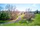 A long, private driveway leading to a secluded home, surrounded by mature trees and a green lawn at 2274 W Huntsville Rd, Pendleton, IN 46064