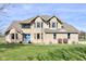 Stunning brick two-story home with a manicured lawn and a welcoming blue front door at 2274 W Huntsville Rd, Pendleton, IN 46064
