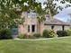 Charming front of house with blue double door, manicured lawn, and lush landscaping at 2274 W Huntsville Rd, Pendleton, IN 46064