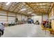 An interior shot of the barn featuring a concrete floor, wood beams, and equipment for storage at 2274 W Huntsville Rd, Pendleton, IN 46064