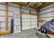 Inside view of a garage with concrete floors and exposed wood beam rafters above at 2274 W Huntsville Rd, Pendleton, IN 46064