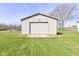 Front view of a one car detached garage with an asphalt driveway and beautiful lawn at 2274 W Huntsville Rd, Pendleton, IN 46064