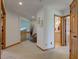 Hallway with carpet, white walls, and wooden doors, leading to a seating area and bathroom at 2274 W Huntsville Rd, Pendleton, IN 46064