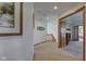 Bright hallway featuring neutral carpet, white walls, and wood trim leading to multiple rooms at 2274 W Huntsville Rd, Pendleton, IN 46064