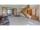 Bright living room with hardwood accents, carpeted floors, and a staircase at 2274 W Huntsville Rd, Pendleton, IN 46064