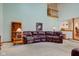 Spacious living room with a brick fireplace, leather sofa, vaulted ceilings, and access to an upper level loft at 2274 W Huntsville Rd, Pendleton, IN 46064