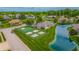Aerial view of community tennis and basketball courts near pond and manicured lawns at 2326 Saddle Dr, Shelbyville, IN 46176