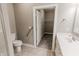 Bright bathroom with a toilet, sink vanity, and walk-in closet, blending style and functionality at 2326 Saddle Dr, Shelbyville, IN 46176
