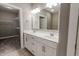 Contemporary bathroom featuring double sinks, a large mirror, and a walk-in closet at 2326 Saddle Dr, Shelbyville, IN 46176