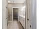 Bright bathroom with dual sink vanity, tiled floor, and modern fixtures. Glass shower door at 2326 Saddle Dr, Shelbyville, IN 46176