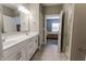 Bathroom featuring double sinks, open walk-in shower and view into the adjacent bedroom at 2326 Saddle Dr, Shelbyville, IN 46176