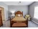 Comfortable bedroom with a wooden bed frame, plush bedding, and soft gray carpeting at 2326 Saddle Dr, Shelbyville, IN 46176