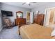Bright bedroom featuring soft carpet, a comfortable bed, and classic wooden furniture at 2326 Saddle Dr, Shelbyville, IN 46176