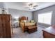 Cozy bedroom features a wooden bed frame, plush bedding, and soft carpeting at 2326 Saddle Dr, Shelbyville, IN 46176