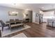 Elegant dining area featuring a farmhouse-style table, a stylish chandelier, and hardwood floors at 2326 Saddle Dr, Shelbyville, IN 46176