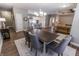Open-concept dining area boasts stylish table and chairs, seamlessly flowing into the modern kitchen and comfortable living room at 2326 Saddle Dr, Shelbyville, IN 46176