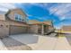 Spacious home featuring a large driveway leading to a two-car garage and a charming covered front porch at 2326 Saddle Dr, Shelbyville, IN 46176