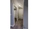 Hallway leads to the bath and a door with neutral walls and plush carpet at 2326 Saddle Dr, Shelbyville, IN 46176