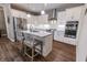 Well-equipped kitchen with stainless steel appliances, white cabinets, granite countertops, and a central island with seating at 2326 Saddle Dr, Shelbyville, IN 46176