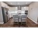 Modern kitchen with stainless steel refrigerator, white cabinets, granite countertops, and stylish bar stool seating at 2326 Saddle Dr, Shelbyville, IN 46176