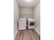 Laundry room featuring modern washer and dryer units, and a storage shelf at 2326 Saddle Dr, Shelbyville, IN 46176