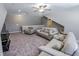 Spacious living room with plush carpeting, neutral walls, and multiple seating options, including sofas and armchairs at 2326 Saddle Dr, Shelbyville, IN 46176