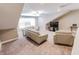 A well-lit living room has neutral walls, plush carpeting, and modern seating arrangements with a ceiling fan at 2326 Saddle Dr, Shelbyville, IN 46176