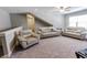 A cozy living room offers neutral decor, plush carpet, and ample seating with a ceiling fan at 2326 Saddle Dr, Shelbyville, IN 46176
