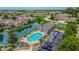 Aerial view of a community pool and clubhouse, nestled near a pond and parking area at 2326 Saddle Dr, Shelbyville, IN 46176