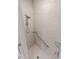Close-up of the corner shower showcasing marble tiles, chrome fixtures and glass shelves at 2326 Saddle Dr, Shelbyville, IN 46176