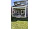 Backyard with covered porch featuring patio furniture and manicured lawn at 2882 Simsbury Ln, Brownsburg, IN 46112