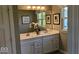 Bathroom with double sink vanity, framed mirror, and decorative art at 2882 Simsbury Ln, Brownsburg, IN 46112