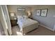 Bedroom with white, upholstered bed and decorative lamps on matching nightstands at 2882 Simsbury Ln, Brownsburg, IN 46112