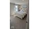 Bedroom with white, upholstered bed and decorative lamps beside a large window at 2882 Simsbury Ln, Brownsburg, IN 46112