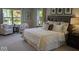Sun-drenched bedroom features a large bed and cozy sitting area near the bright window at 2882 Simsbury Ln, Brownsburg, IN 46112