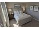 Comfortable bedroom with a white bed, decorative pillows, and dark wood nightstands at 2882 Simsbury Ln, Brownsburg, IN 46112