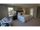 Spacious bedroom with a large bed, accent chair, and natural light from the window at 2882 Simsbury Ln, Brownsburg, IN 46112