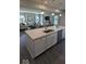 Spacious, open concept featuring a kitchen island that flows into the living room with comfortable neutral seating at 2882 Simsbury Ln, Brownsburg, IN 46112