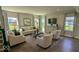 Bright living room featuring modern furniture, hardwood floors, and large windows offering natural light at 2882 Simsbury Ln, Brownsburg, IN 46112