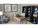 Light-filled home office with wooden desk, gray chair, dark bookcase, and decor at 2882 Simsbury Ln, Brownsburg, IN 46112