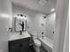 This bathroom features a marble-look tiled shower, a new vanity, and black fixtures at 3262 Orchard Ave, Indianapolis, IN 46218