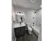 Stylish bathroom with white marble-style tiled shower, modern fixtures, and dark vanity at 3262 Orchard Ave, Indianapolis, IN 46218