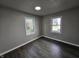 This bedroom features wood-look floors, two windows, and neutral paint at 3262 Orchard Ave, Indianapolis, IN 46218