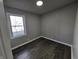 This bedroom features wood-look floors and a window providing natural light at 3262 Orchard Ave, Indianapolis, IN 46218