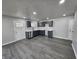 Well-lit kitchen with gray cabinets, stainless steel appliances, and stylish laminate flooring at 3262 Orchard Ave, Indianapolis, IN 46218